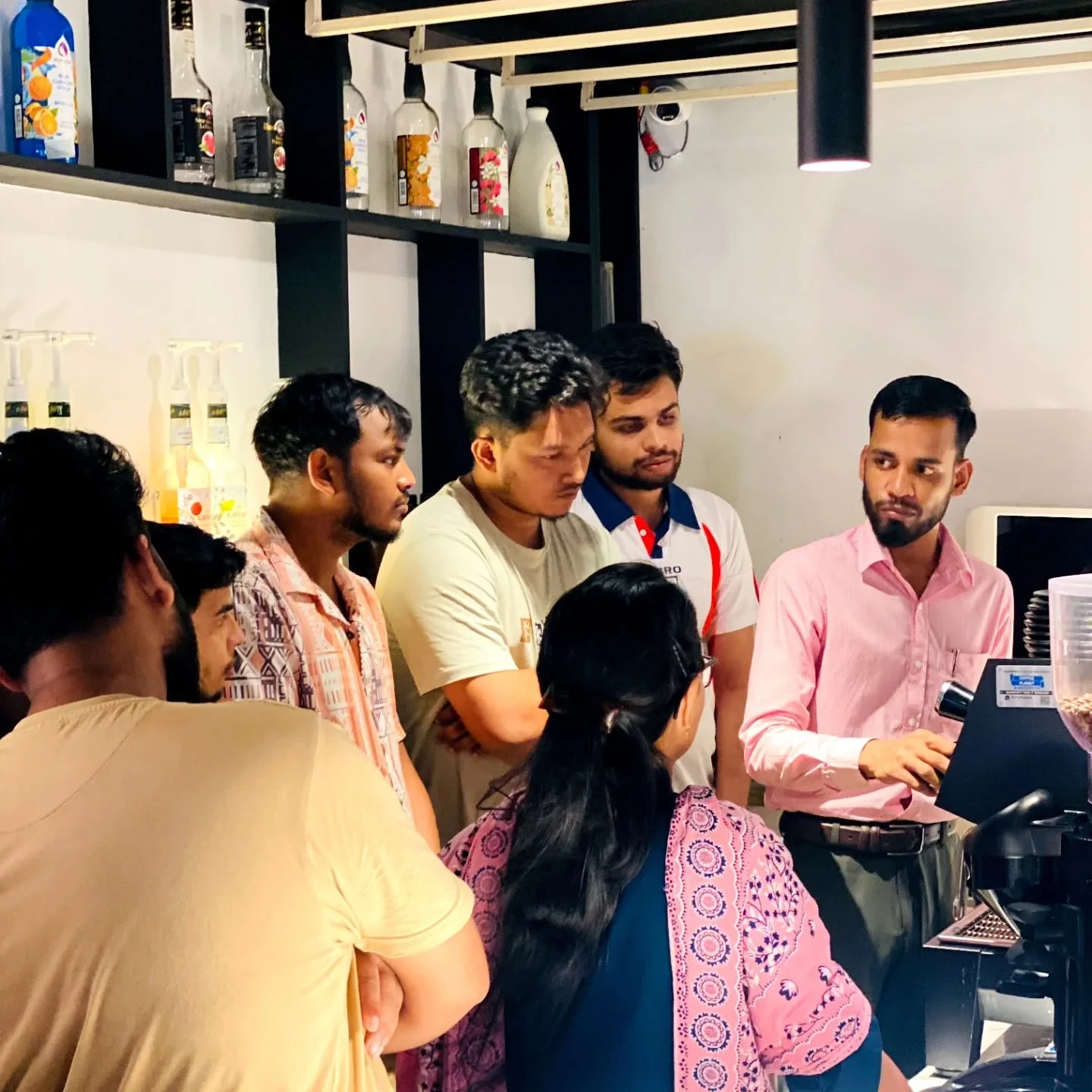 Coffee students gathered around a practical demonstration